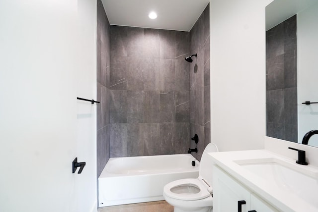 full bathroom with vanity, tiled shower / bath combo, and toilet