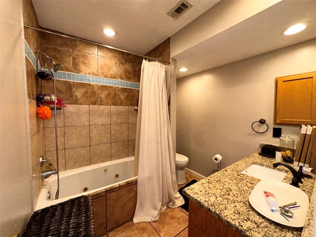 full bathroom featuring shower / tub combo with curtain, vanity, tile patterned flooring, a textured ceiling, and toilet