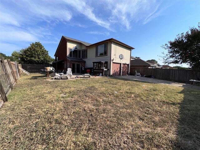 back of house featuring a patio area and a yard