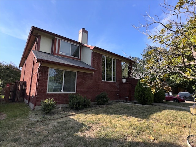 view of side of property with a yard