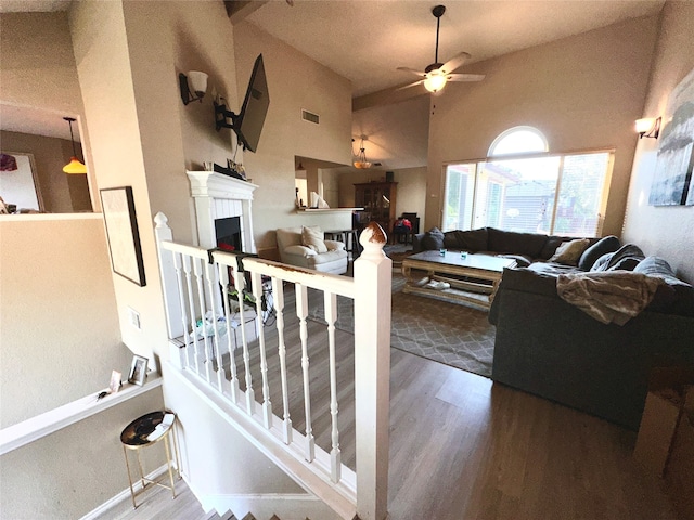 living room featuring ceiling fan, high vaulted ceiling, and wood-type flooring