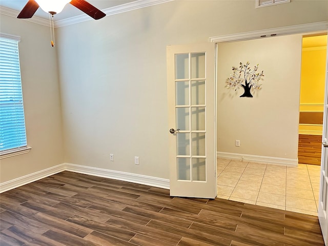 unfurnished room with ornamental molding, dark wood-style floors, ceiling fan, and baseboards