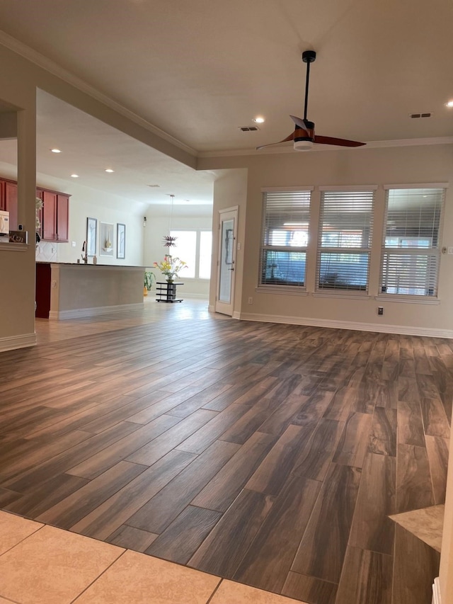 unfurnished living room with recessed lighting, ceiling fan, dark wood-style flooring, visible vents, and crown molding