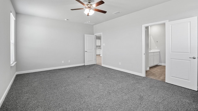 unfurnished bedroom with ceiling fan, carpet, and connected bathroom