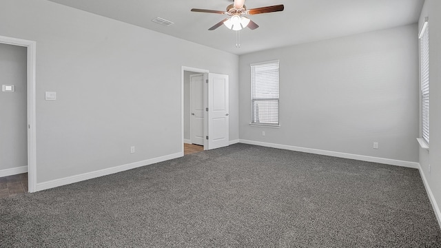 carpeted empty room featuring ceiling fan