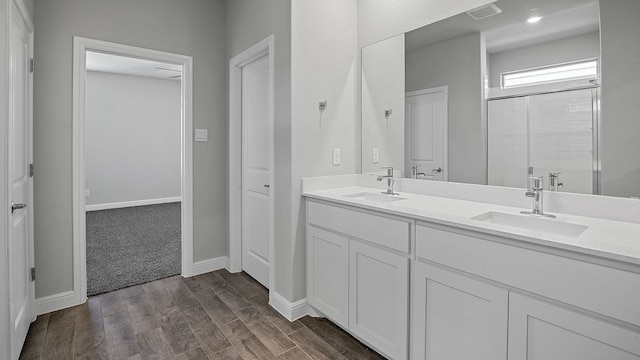 bathroom featuring dual vanity and hardwood / wood-style floors