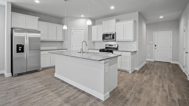 kitchen featuring light wood-type flooring, tasteful backsplash, white cabinetry, appliances with stainless steel finishes, and sink