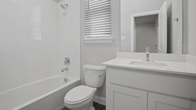 full bathroom featuring vanity, tiled shower / bath combo, and toilet