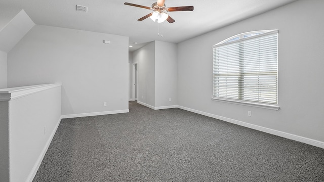 carpeted spare room featuring a wealth of natural light, ceiling fan, and vaulted ceiling