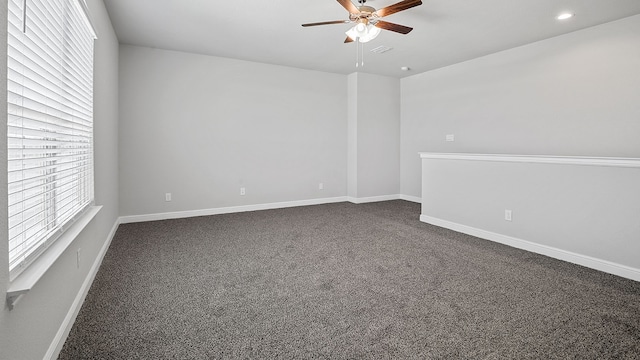 carpeted spare room featuring ceiling fan