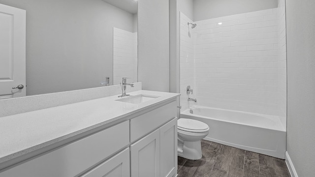 full bathroom with hardwood / wood-style floors, shower / bath combination, toilet, and vanity