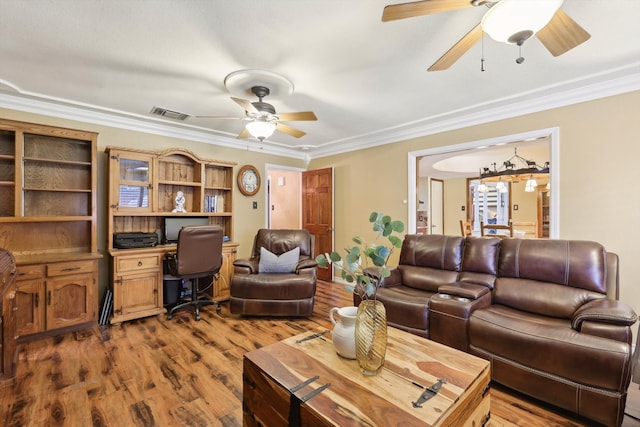 living room featuring hardwood / wood-style flooring, crown molding, and ceiling fan