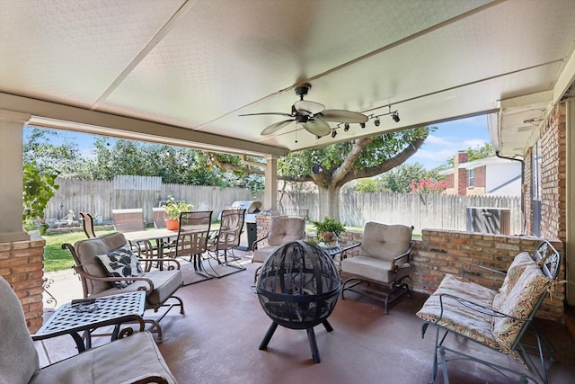 view of patio / terrace with ceiling fan and a fire pit