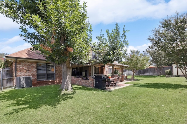 rear view of property featuring a patio, a yard, and cooling unit