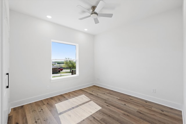 spare room with wood-type flooring and ceiling fan