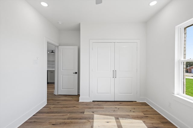 unfurnished bedroom with a closet and hardwood / wood-style flooring