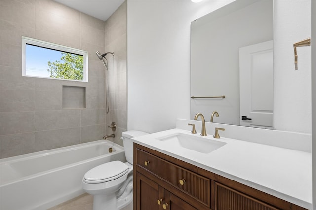 full bathroom featuring vanity, tiled shower / bath, and toilet