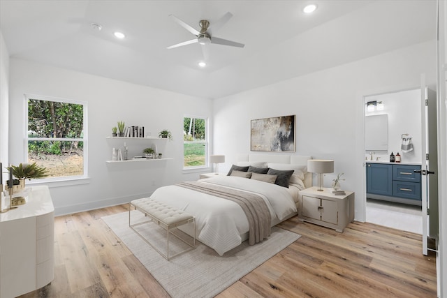 bedroom with ceiling fan, light hardwood / wood-style flooring, ensuite bath, and multiple windows