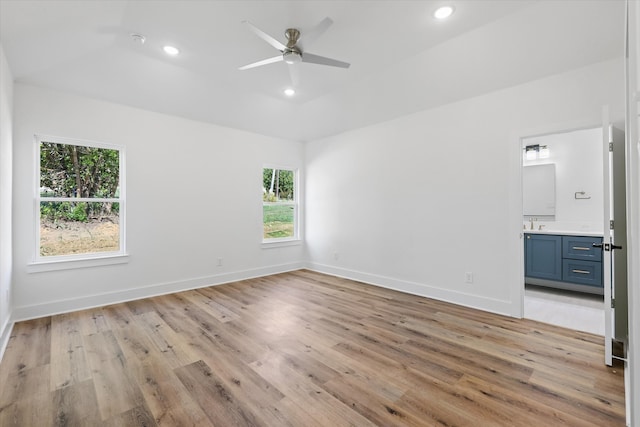 unfurnished bedroom with light hardwood / wood-style flooring, ensuite bath, and ceiling fan