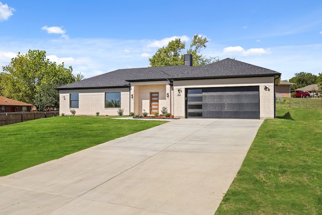 view of front of home featuring a front yard and a garage