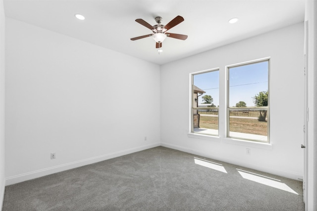 spare room featuring ceiling fan and carpet floors