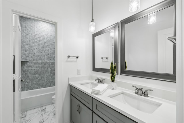 full bathroom featuring vanity, toilet, and tiled shower / bath combo