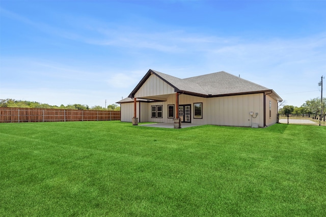 rear view of property with a patio and a lawn