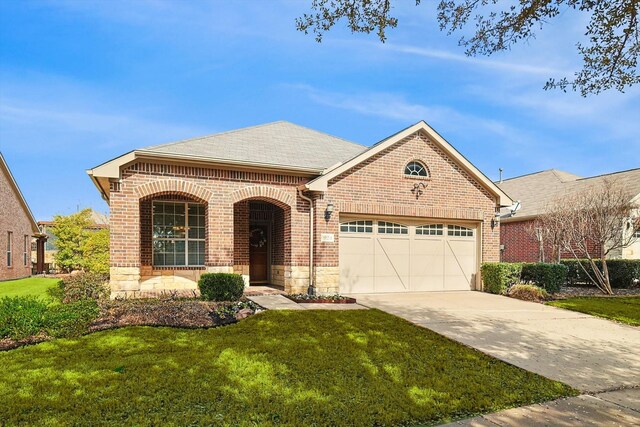 view of front of home with a garage and a front lawn