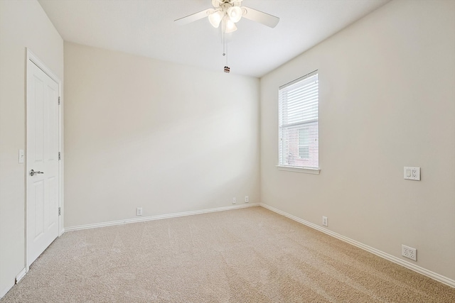 empty room with ceiling fan and light carpet