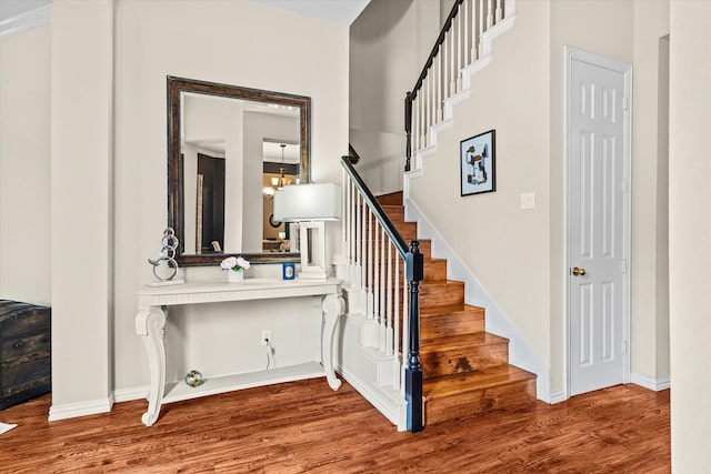 stairway with hardwood / wood-style flooring