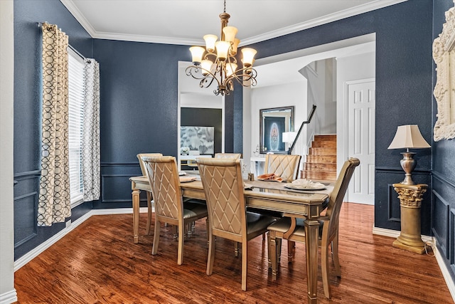 dining area featuring crown molding, wood-type flooring, and a chandelier