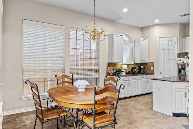 dining room with a notable chandelier and light tile patterned floors