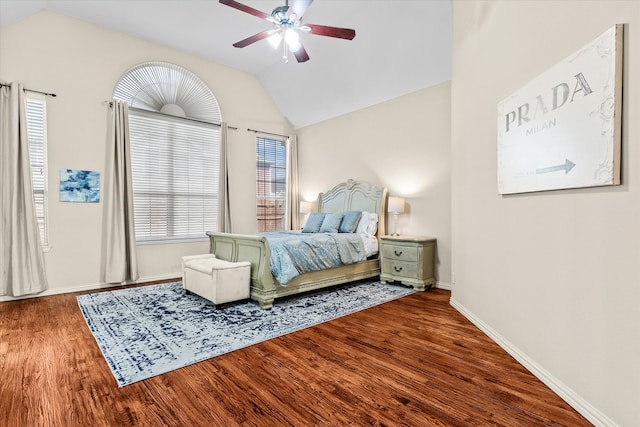 bedroom with ceiling fan, vaulted ceiling, and hardwood / wood-style flooring