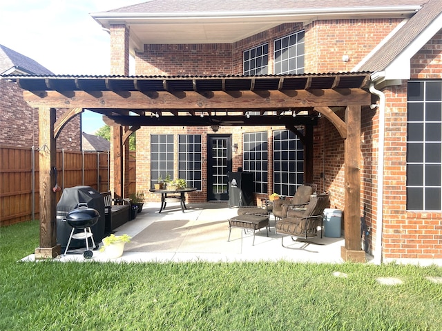 exterior space with ceiling fan, a pergola, a yard, and a patio