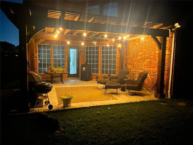 patio at twilight with a yard, a grill, and a pergola