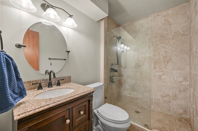 bathroom featuring toilet, an enclosed shower, and vanity