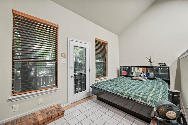 tiled bedroom featuring access to outside and lofted ceiling