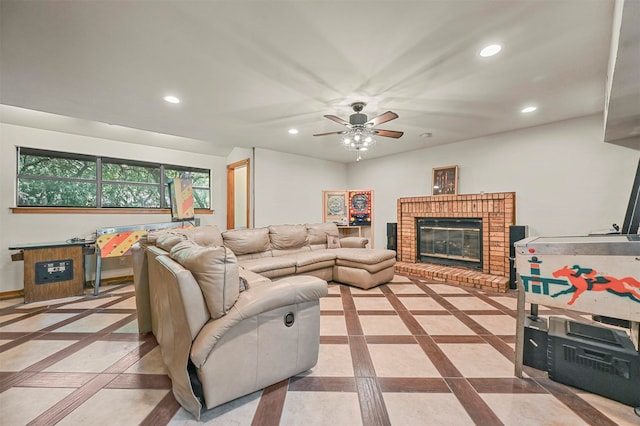 living room featuring ceiling fan, a brick fireplace, and light tile patterned floors