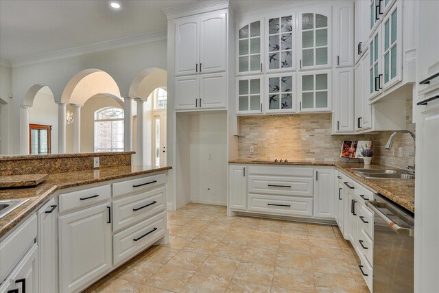 kitchen with sink, stainless steel dishwasher, tasteful backsplash, white cabinetry, and crown molding