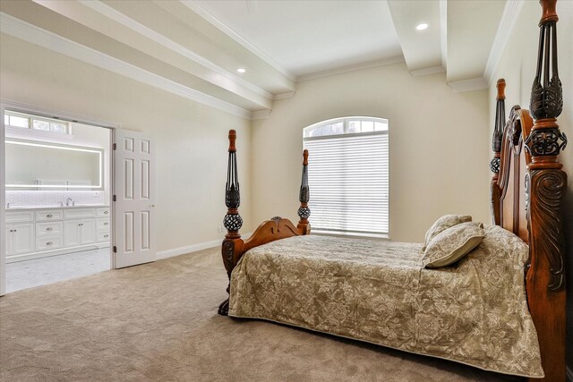 carpeted bedroom with multiple windows, ensuite bath, and crown molding