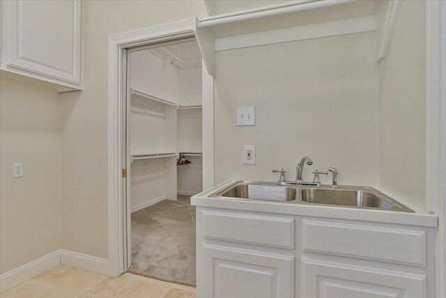 washroom with light colored carpet and sink