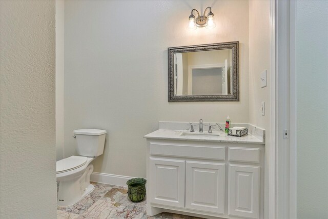 bathroom with tile patterned flooring, toilet, and vanity