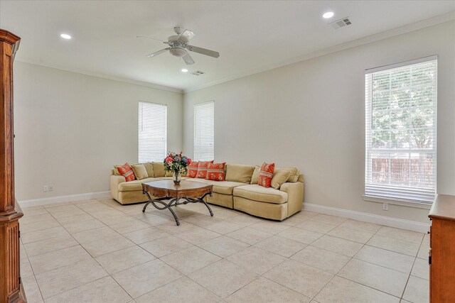 living room with ceiling fan, crown molding, and light tile patterned flooring