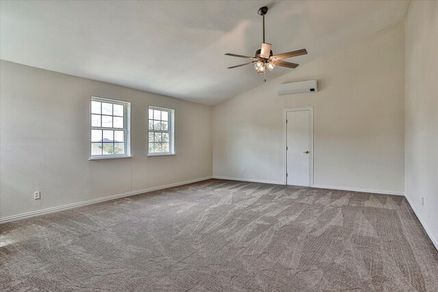 carpeted spare room with ceiling fan, vaulted ceiling, and a wall mounted air conditioner