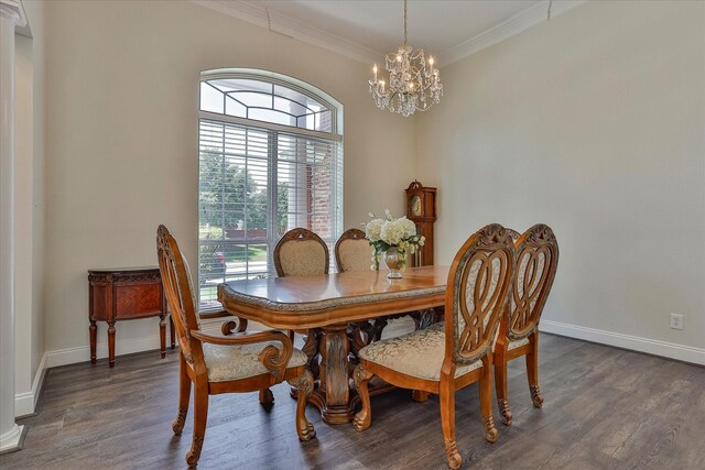 dining room with dark wood-type flooring, ornamental molding, and a chandelier