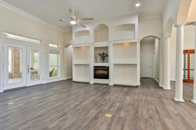 unfurnished living room featuring hardwood / wood-style floors, built in shelves, french doors, ornate columns, and ceiling fan