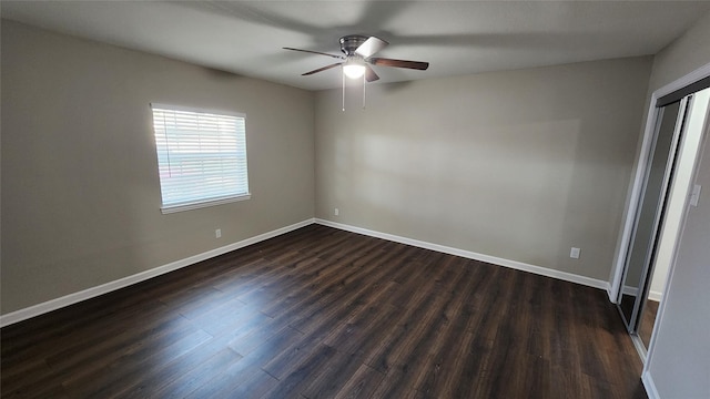 unfurnished bedroom featuring dark wood-type flooring and ceiling fan