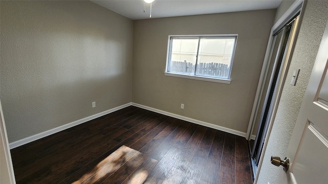 spare room featuring wood-type flooring