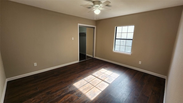 unfurnished bedroom with dark wood-type flooring, ceiling fan, and a closet