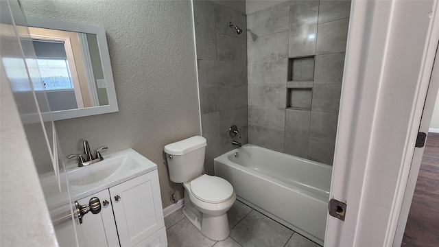 full bathroom featuring vanity, tile patterned floors, toilet, and tiled shower / bath